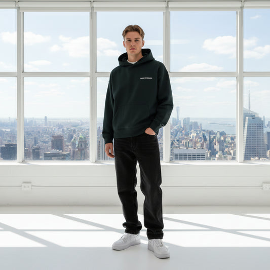 Black hoodie with white chest logo on male model in studio