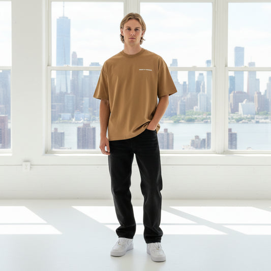Brown t-shirt with a white chest logo on male model in studio