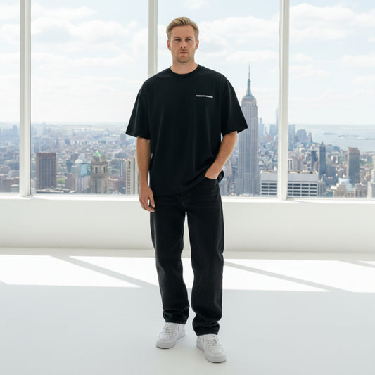 Black t-shirt with white chest logo on male model in photo studio