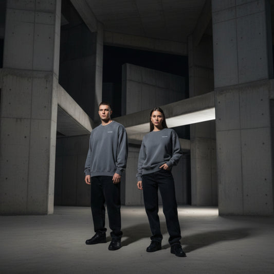 Grey sweatshirt with white chest logo on both male and female model