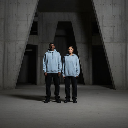 Light blue hoodie with small white chest logo on both male and female model