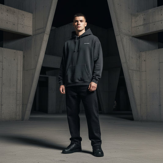 Black hoodie with a small white logo on male model
