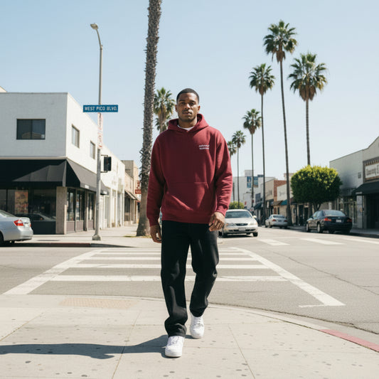 Burgundy hoodie with white text on chest on male model in LA