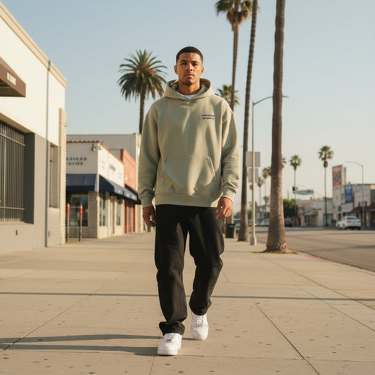 Beige hoodie with 'unified sympathy' chest print on male model in LA